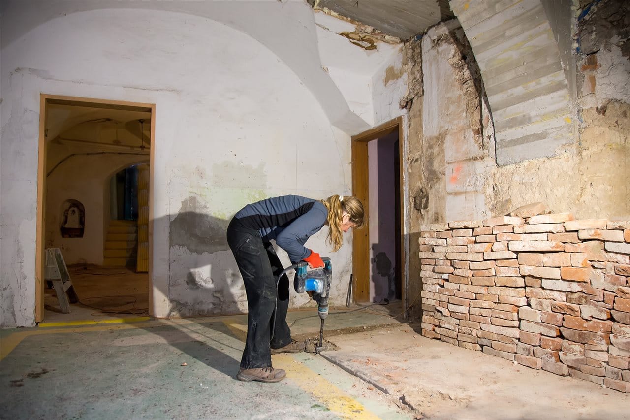 woman drilling the basement floor | Be Informed Home Inspections | Bathroom in the basement Fort Worth woman drilling the basement floor | Be Informed Home Inspections | Bathroom in the basement Fort Worth