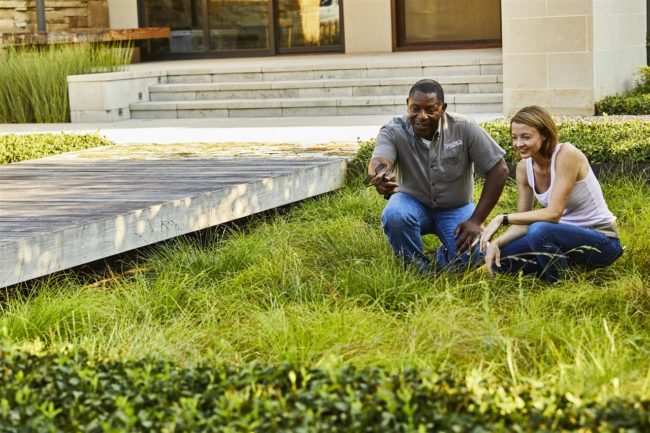 landscape contractor and homeowner in the lawn | Be Informed Home Inspections | landscape professional Fort Worth