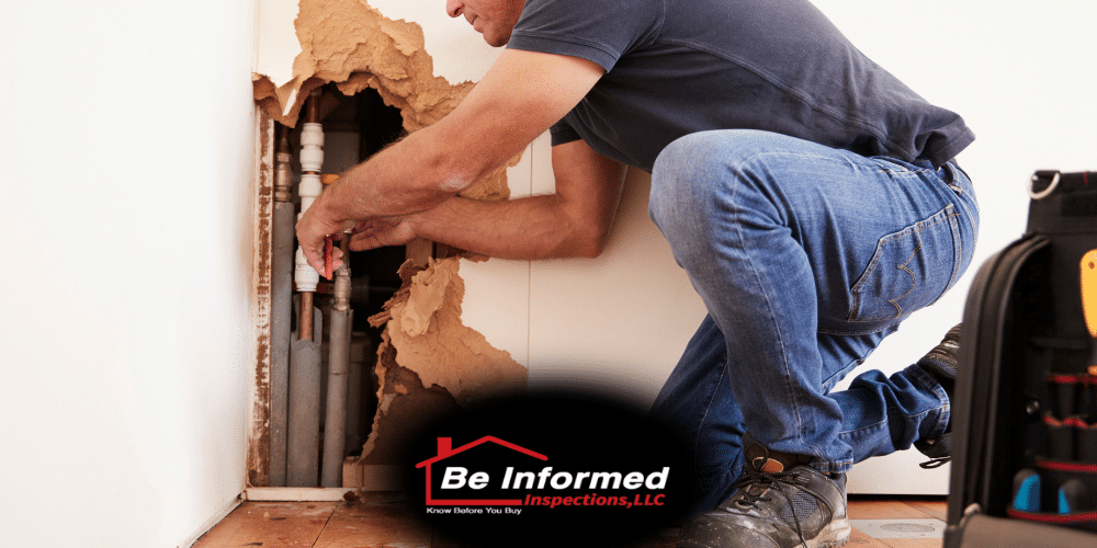 Home inspector evaluating exposed plumbing pipes behind damaged drywall during home inspection in Dallas Fort Worth TX